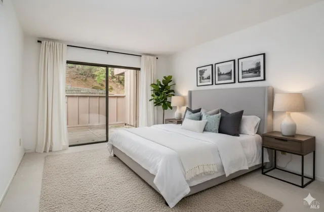 a bedroom with a large bed and a window