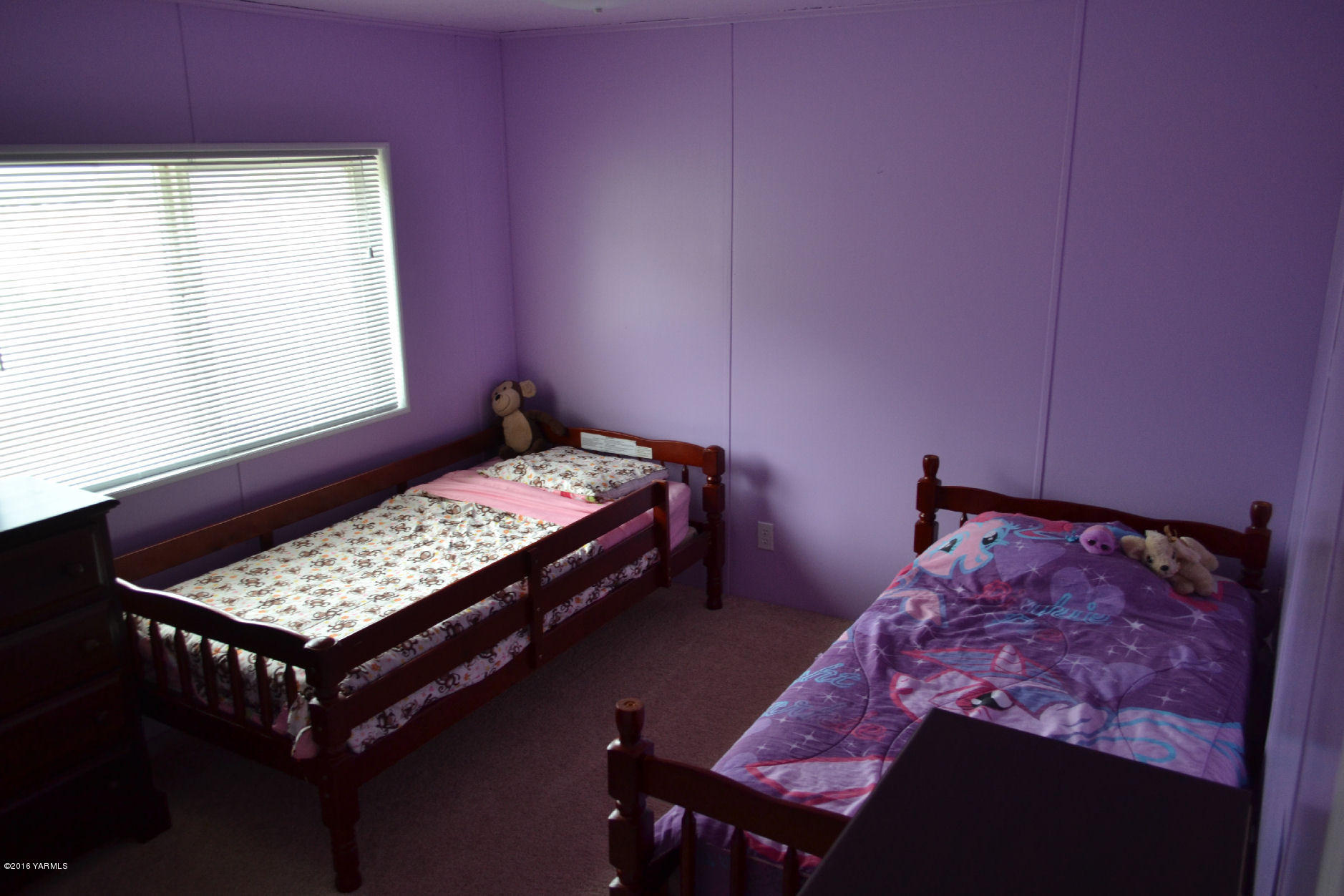 307 Prairie Road Moxee, WA 98936 - Photo 9 of 9 a bed sitting in a bedroom next to a window