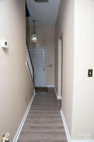 a view of a hallway with wooden floor