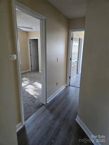 a view of hallway with wooden floor