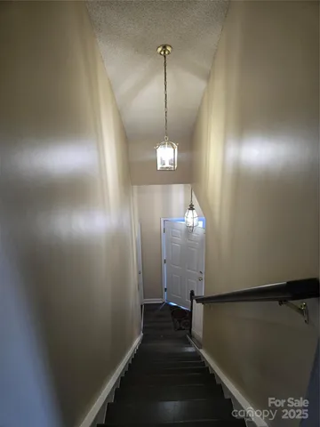 a view of a hallway with stairs