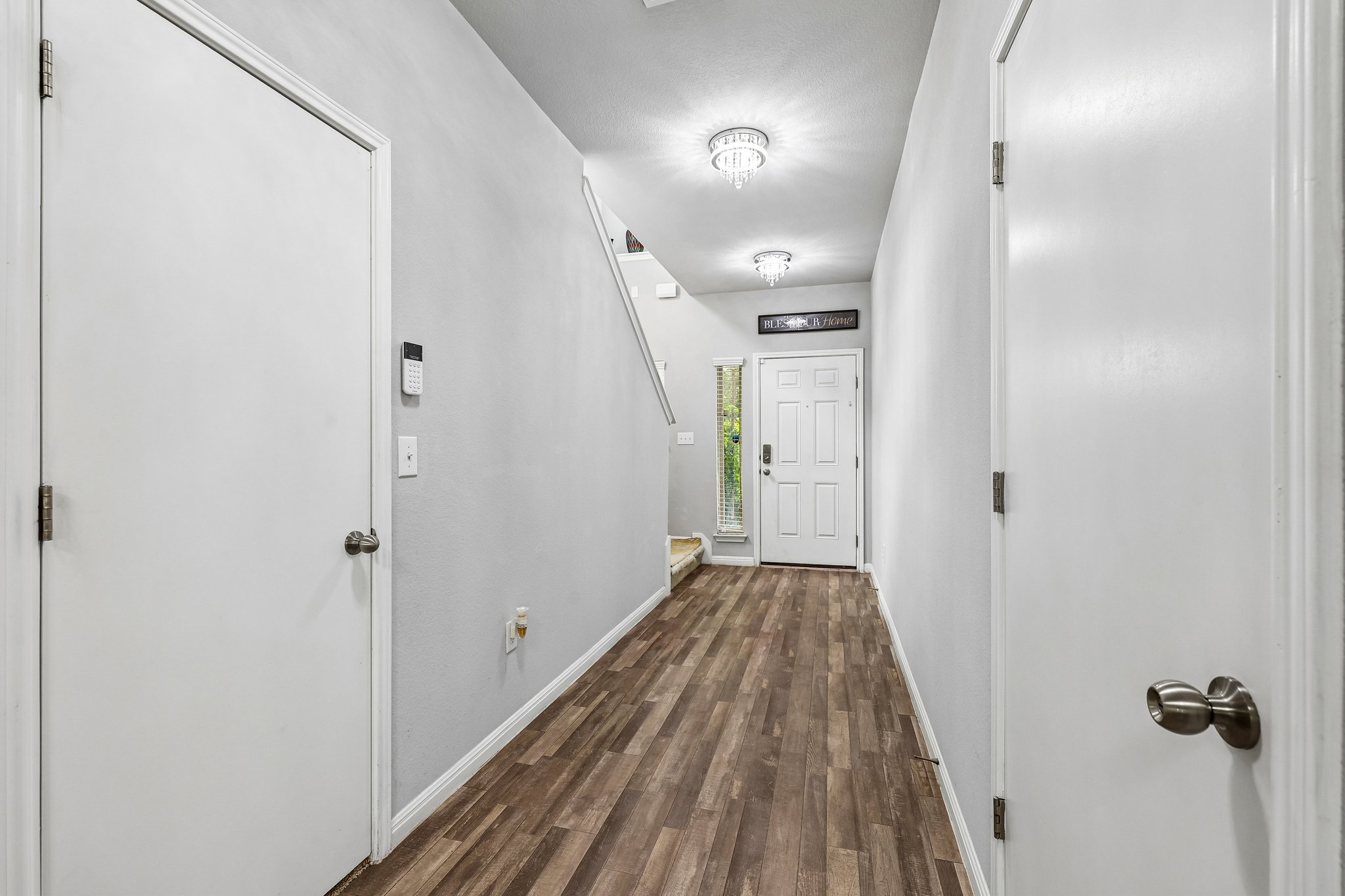 387 Guemal Road Buda, TX 78610 - Photo 3 of 39 Entryway featuring wood-finish flooring, light gray walls, and white trim