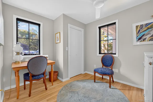 a bedroom with bed and glass windows