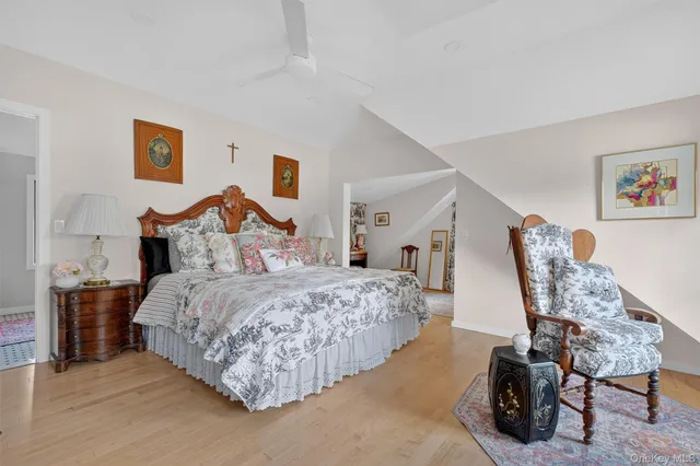 a spacious bedroom with a bed and a flat screen tv