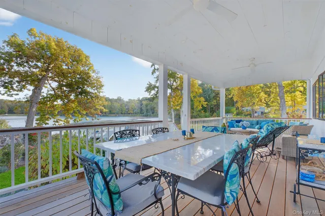 a view of a balcony with furniture and wooden floor
