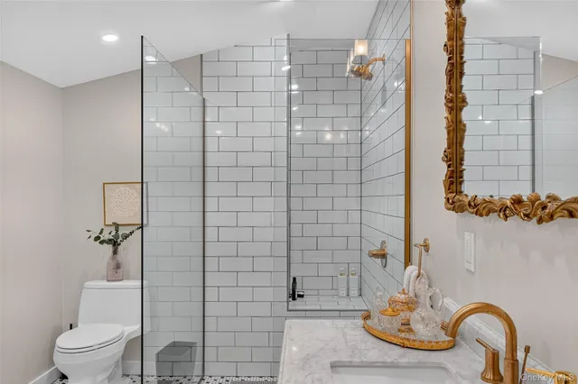 a spacious bathroom with a tub sink and mirror