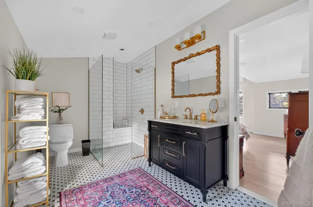 a spacious bedroom with a bed and a lamp on table
