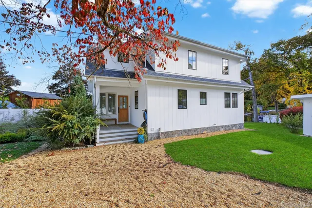 a view of backyard with a barn and plants