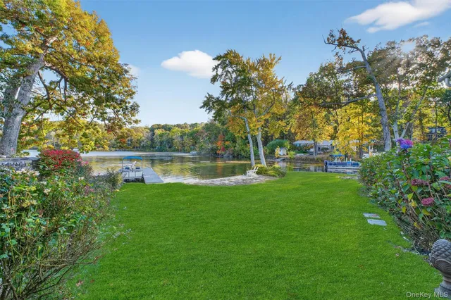 a view of a lake with lawn chairs