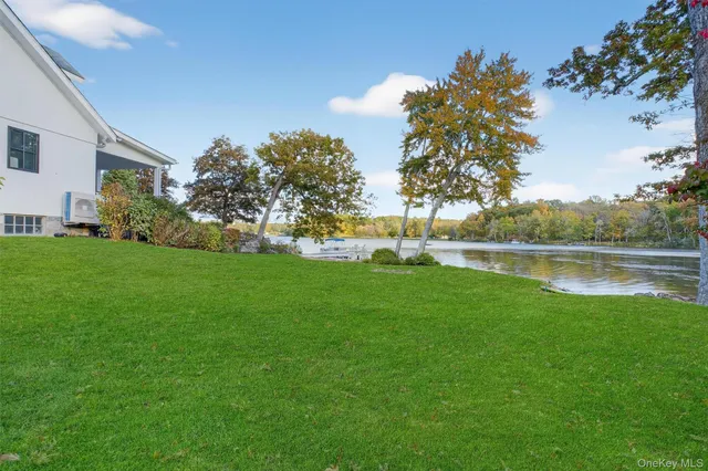 a view of a lake with houses in the back
