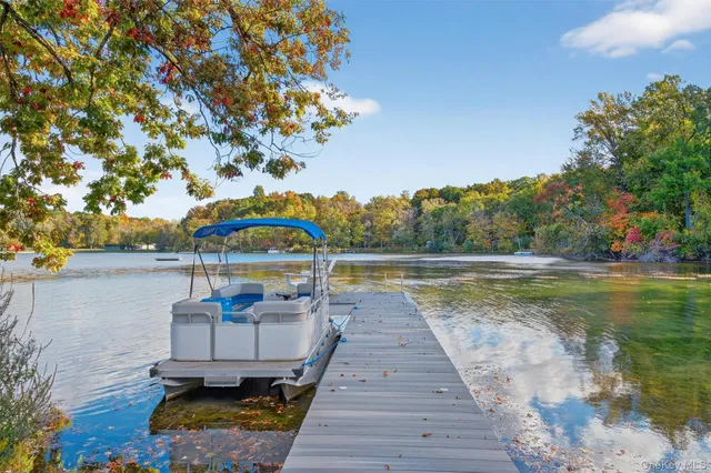 an aerial view of a house with yard swimming pool and outdoor seating