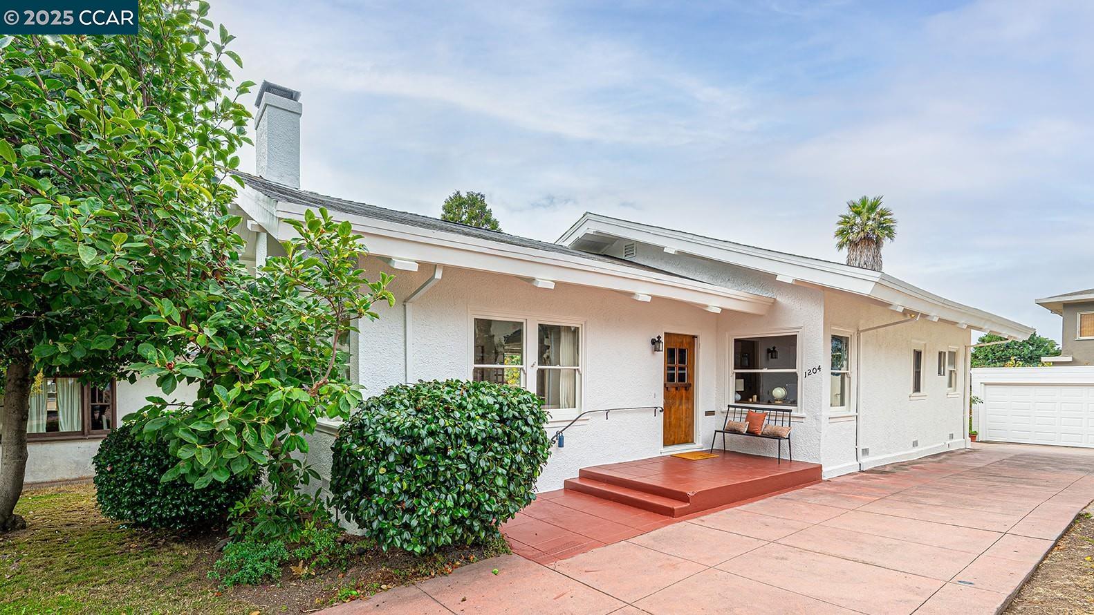 a backyard of a house with table and chairs
