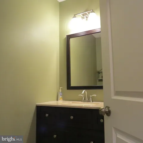 a bedroom with a bed and a flat tv screen on dresser