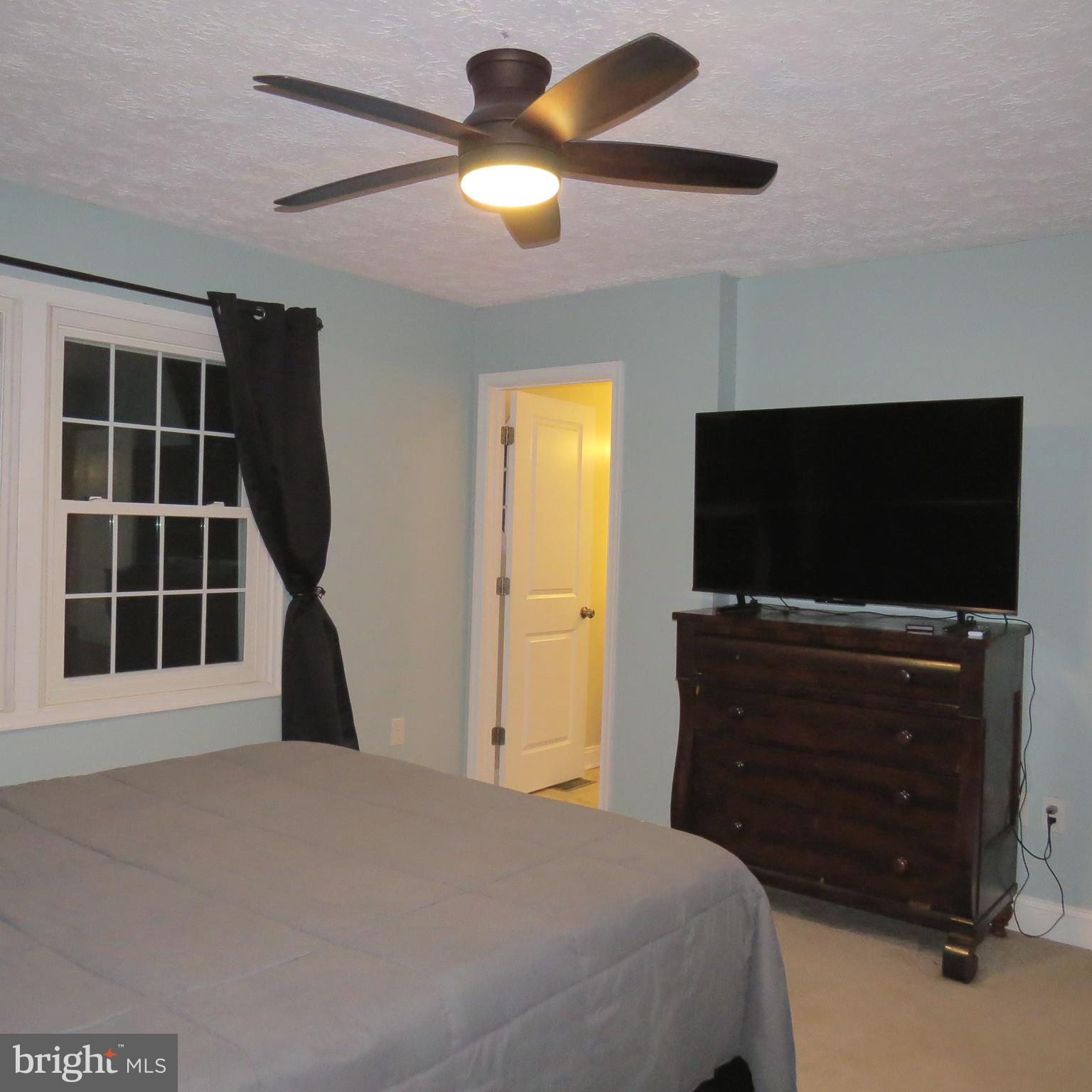 22 Hobb Court Perry Hall, MD 21128 - Photo 19 of 42 a bedroom with a bed and a flat screen tv