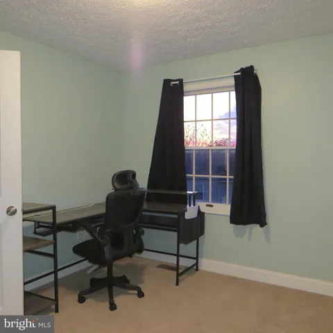 a bench sitting in a room next to a window