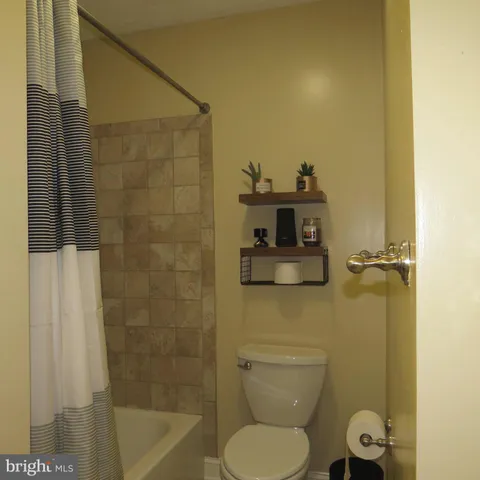 a bathroom with a toilet and a shower