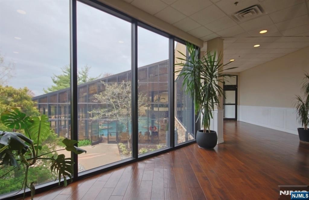 2 Chamonix Drive, Unit 427 Vernon, NJ 07462 - Photo 11 of 11 a living room with furniture large windows and wooden floor