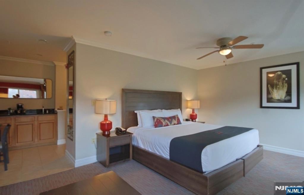 2 Chamonix Drive, Unit 427 Vernon, NJ 07462 - Photo 2 of 11 a bedroom with a bed and a chandelier