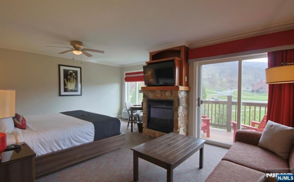 2 Chamonix Drive, Unit 427 Vernon, NJ 07462 - Photo 3 of 11 a bedroom with furniture and a fireplace