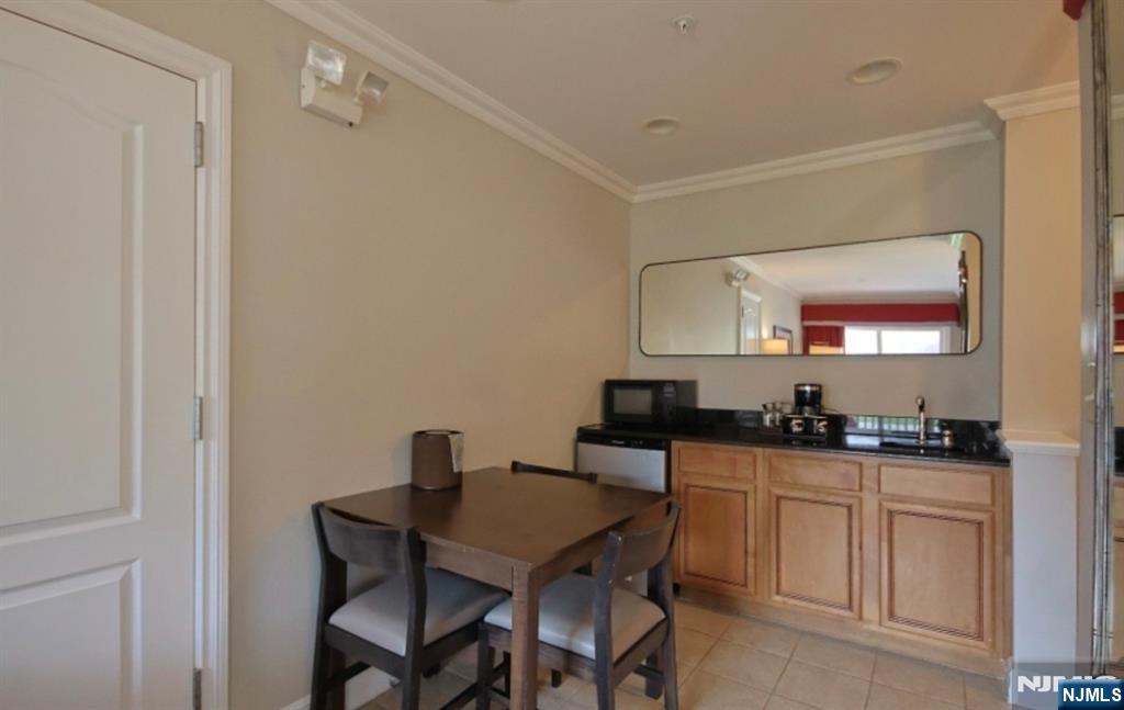 2 Chamonix Drive, Unit 427 Vernon, NJ 07462 - Photo 7 of 11 a kitchen with a table and chairs in it