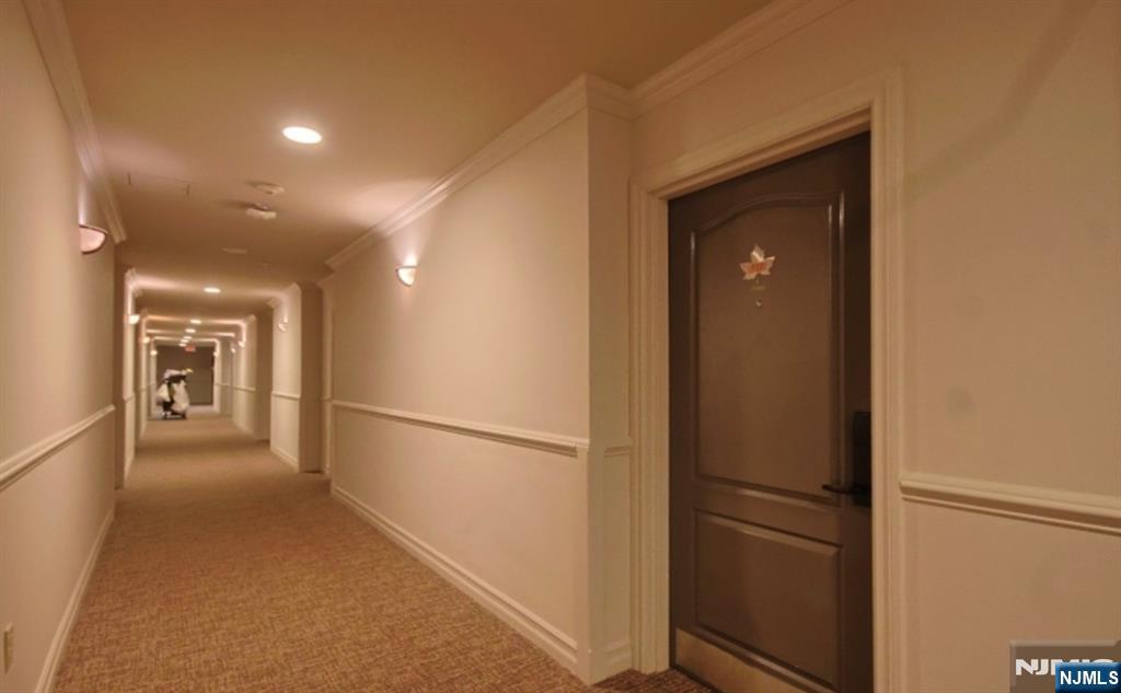 2 Chamonix Drive, Unit 427 Vernon, NJ 07462 - Photo 10 of 11 a view of a hallway with a refrigerator