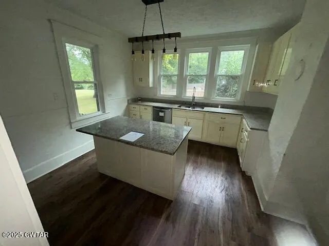 a dining room with wooden floor a chandelier a wooden floor and a window