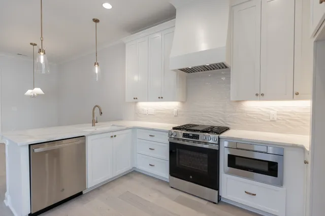 a kitchen with white cabinets and white appliances