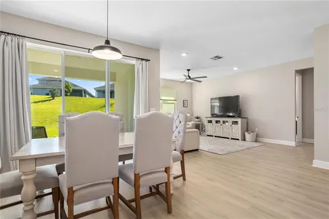 a living room with furniture a flat screen tv and a large window