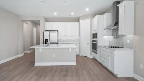 a kitchen with stainless steel appliances a white stove top oven cabinets and a refrigerator