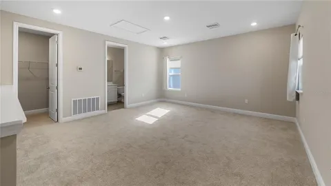 an empty room with windows and closet