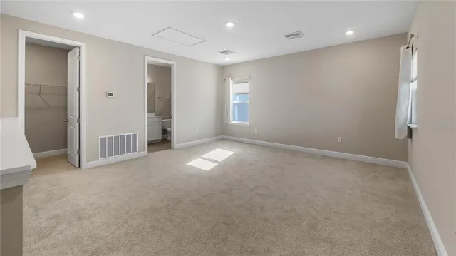 an empty room with windows and closet