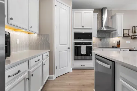 a kitchen with stainless steel appliances granite countertop a stove a sink and a refrigerator