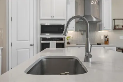 a kitchen with a sink cabinets and stainless steel appliances