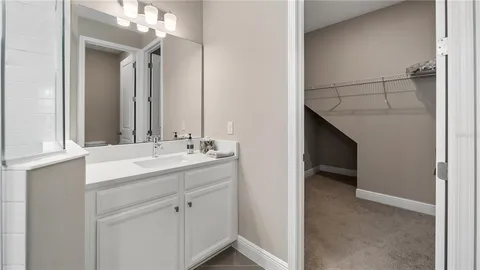 a en suite bathroom with a sink and a mirror