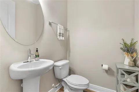 a bathroom with a sink toilet and a mirror