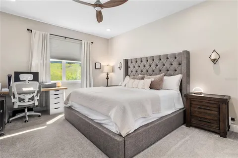 a bed room with a bed and a chair