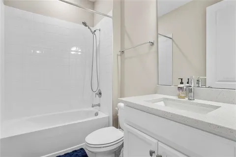 a bathroom with a sink a toilet and a bathtub
