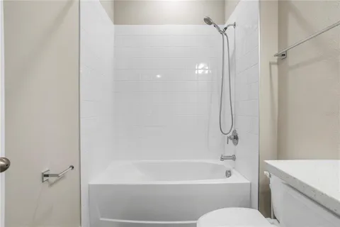 a bathroom with a shower a bathtub and a shower