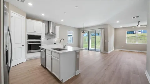 a kitchen with stainless steel appliances granite countertop a stove and a refrigerator