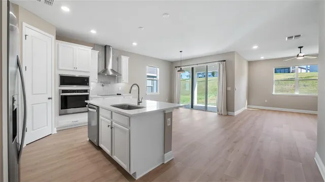 a kitchen with stainless steel appliances granite countertop a stove and a refrigerator