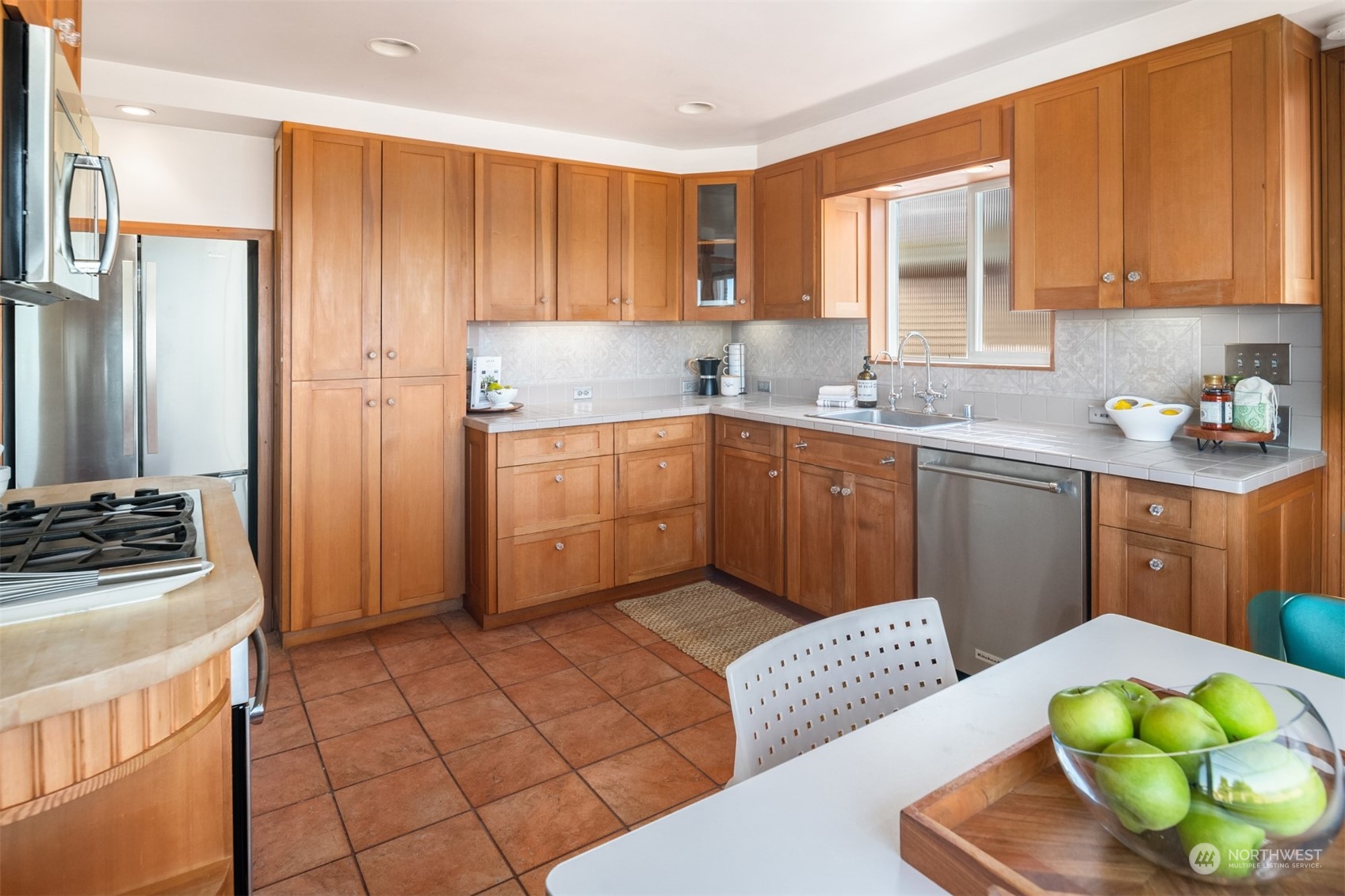 3711 55th Avenue Southwest Seattle, WA 98116 - Photo 15 of 33 a kitchen with stainless steel appliances granite countertop a sink dishwasher stove and refrigerator