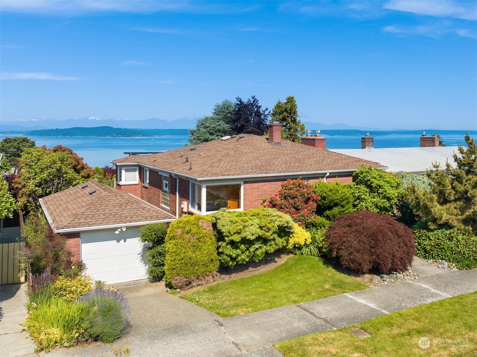 3711 55th Avenue Southwest Seattle, WA 98116 - Photo 2 of 33 a front view of a house with a yard