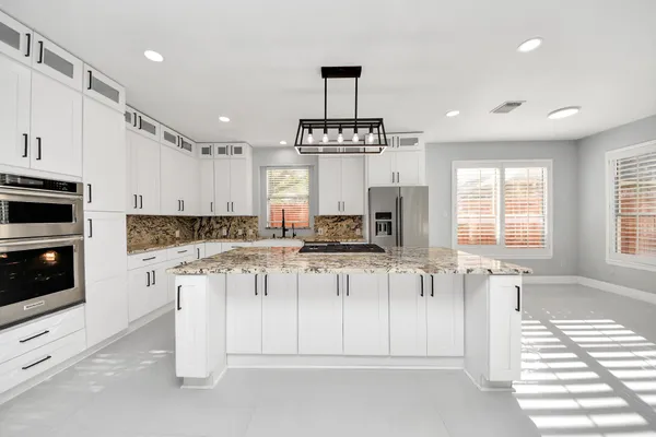 a kitchen with a stove a sink and a refrigerator