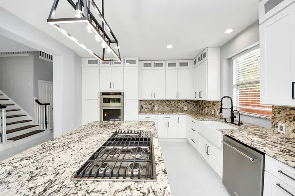 a kitchen with kitchen island a stove sink and refrigerator