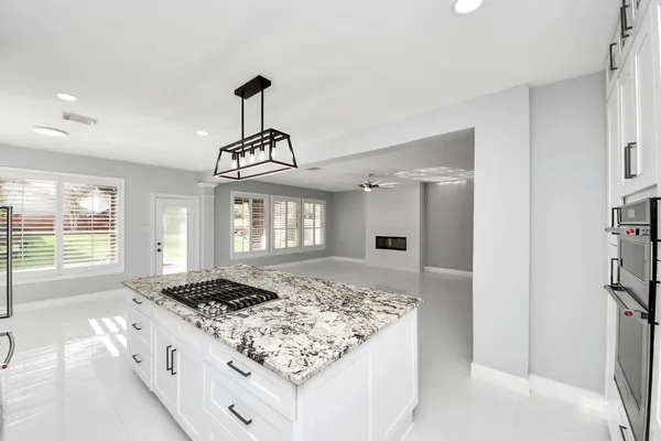 a kitchen with sink stove and refrigerator