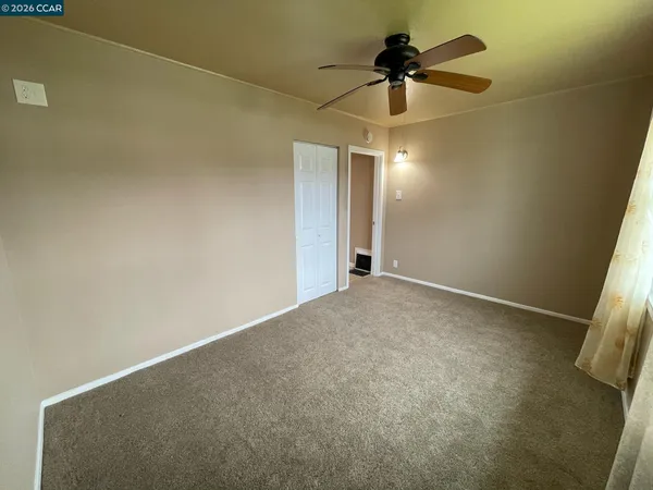a view of a livingroom with a ceiling fan and chandelier fan