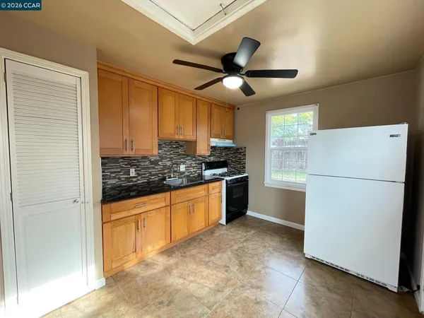 a kitchen with stainless steel appliances granite countertop a refrigerator and a sink