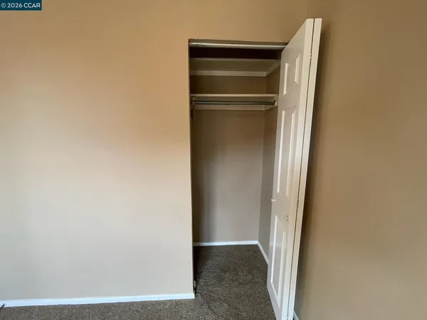 a view of walk in closet with empty room
