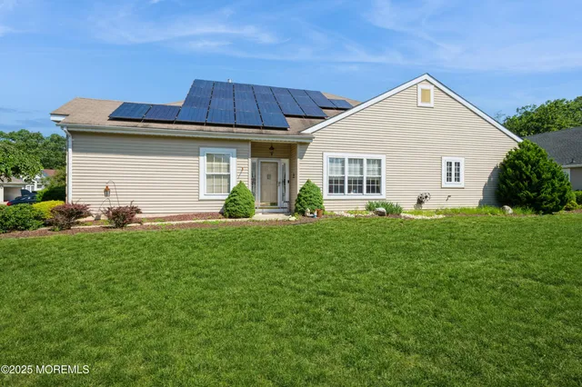a view of a house with pool and a yard