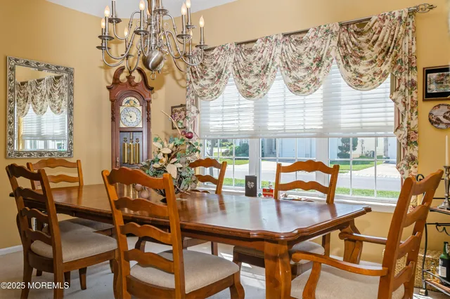 a dining room with furniture and wooden floor